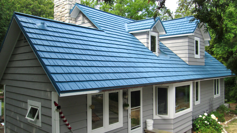 Blue Rustic Shingle Roof on a Grey House with White Trim