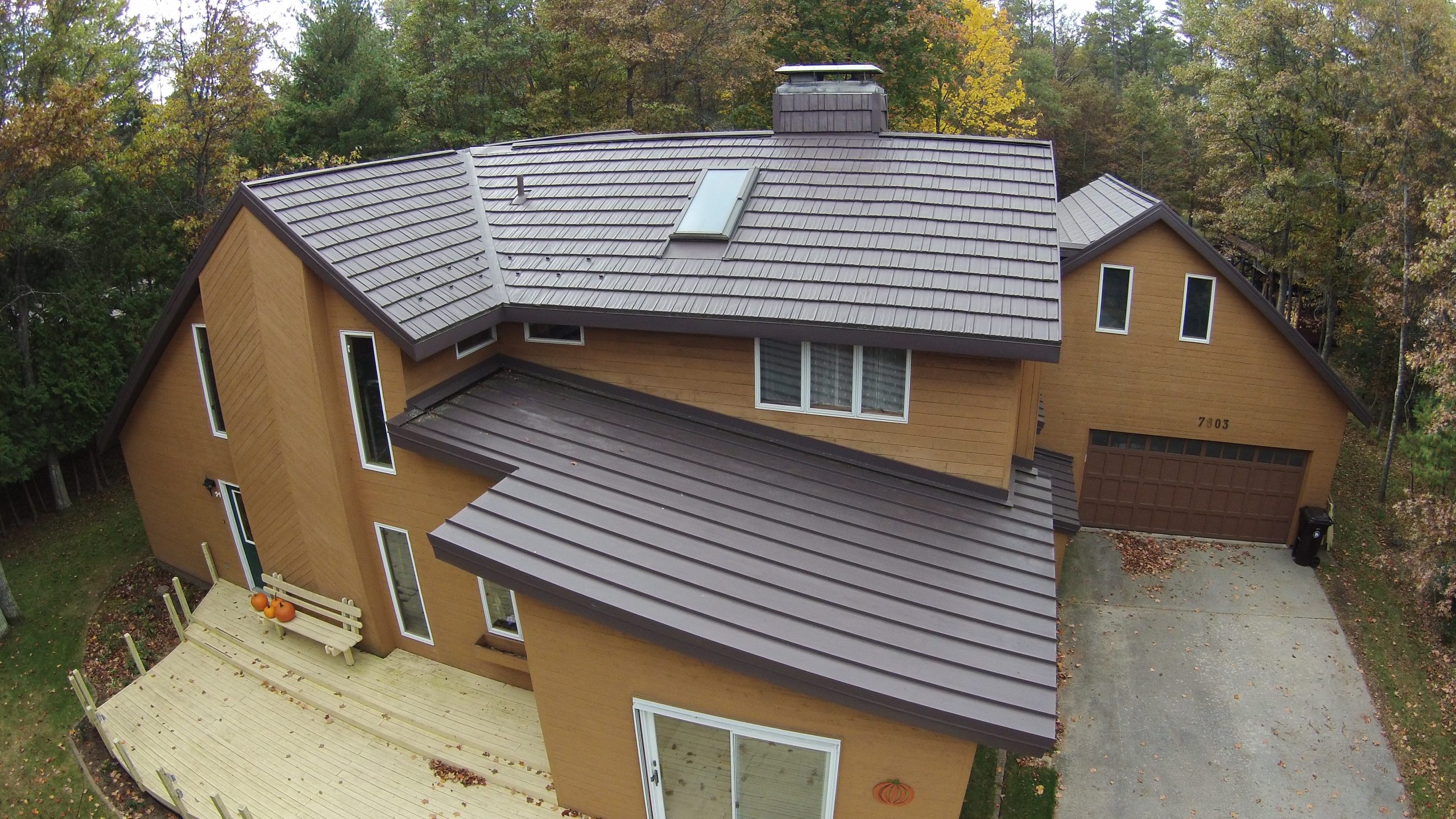 Caramel House with Brown Standing Seam Metal Roof