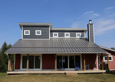 Gray house with gray Standing Sam Metal Roof