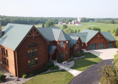 Brown Home with Green Rustic Shingle Roof