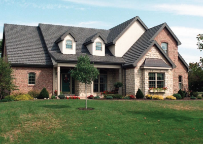 Brick Home with Black Country Manor Shake Metal Roof