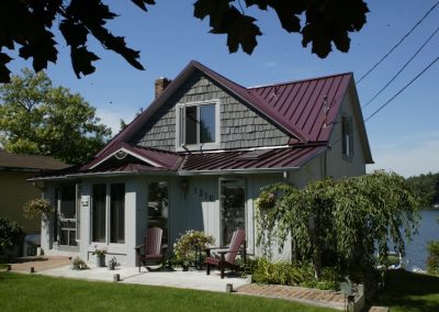 Red Standing Seam Roof on a Gray House
