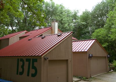 Tan Home with Red Standing Seam Roof