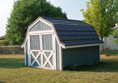 Blue Shed with White Trim and a Grey Rustic Shingle Roof