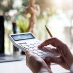 Hands holding a white calculator