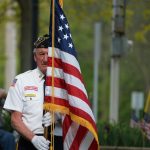 Male Veteran holding an American Flag