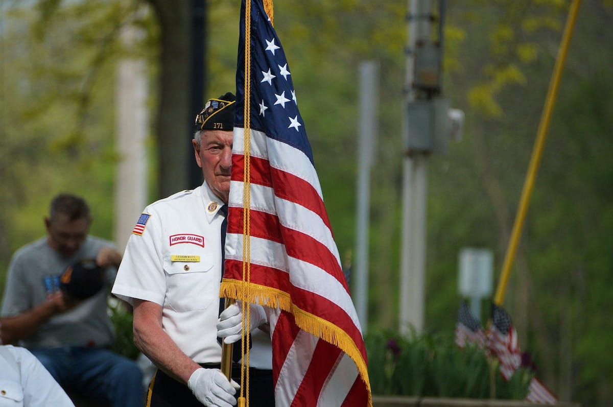 Male Veteran holding an American Flag