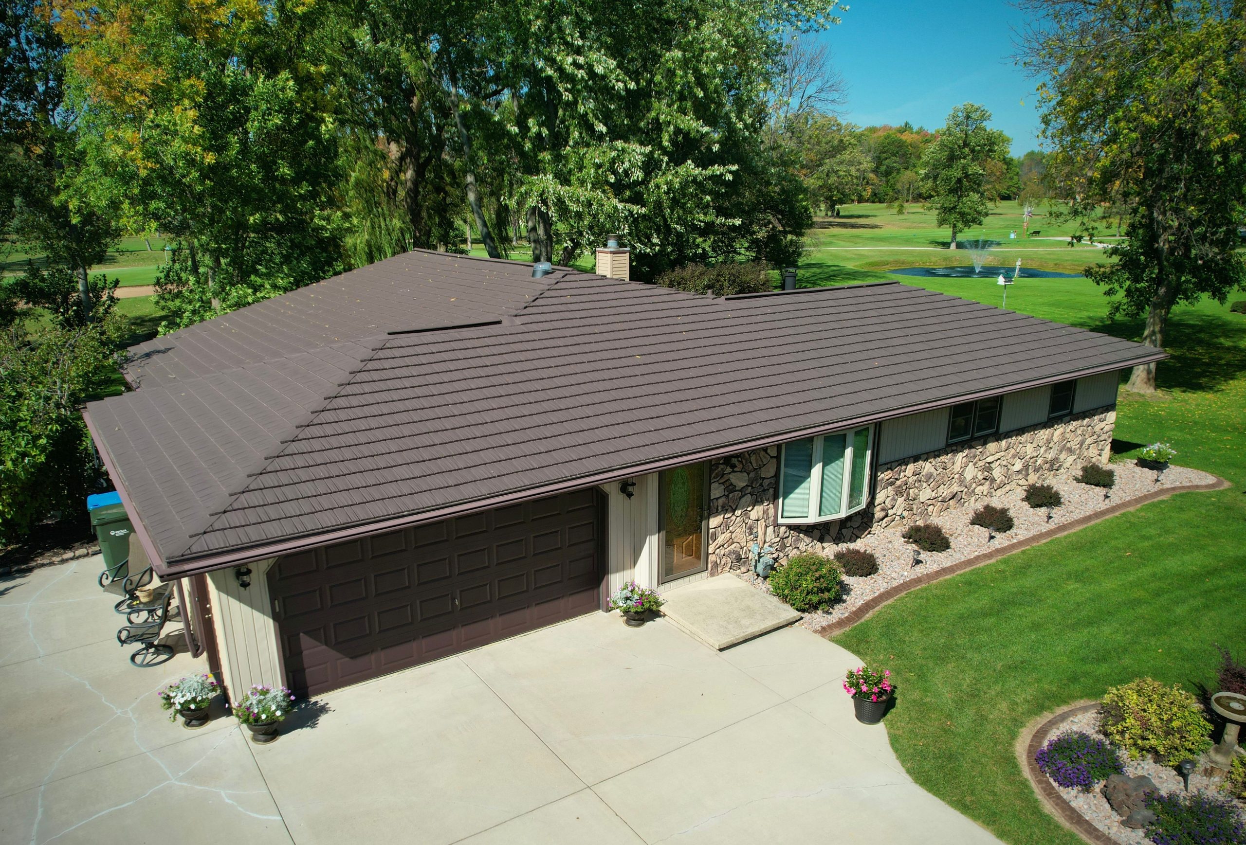 Brown Oxford metal shingles on a brick house