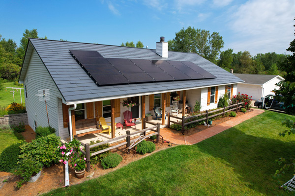 Single level home with a metal roof with solar panels
