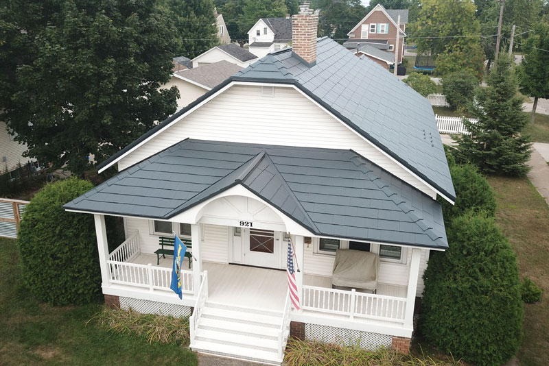 White home with green Oxford Shingle Metal Roofing